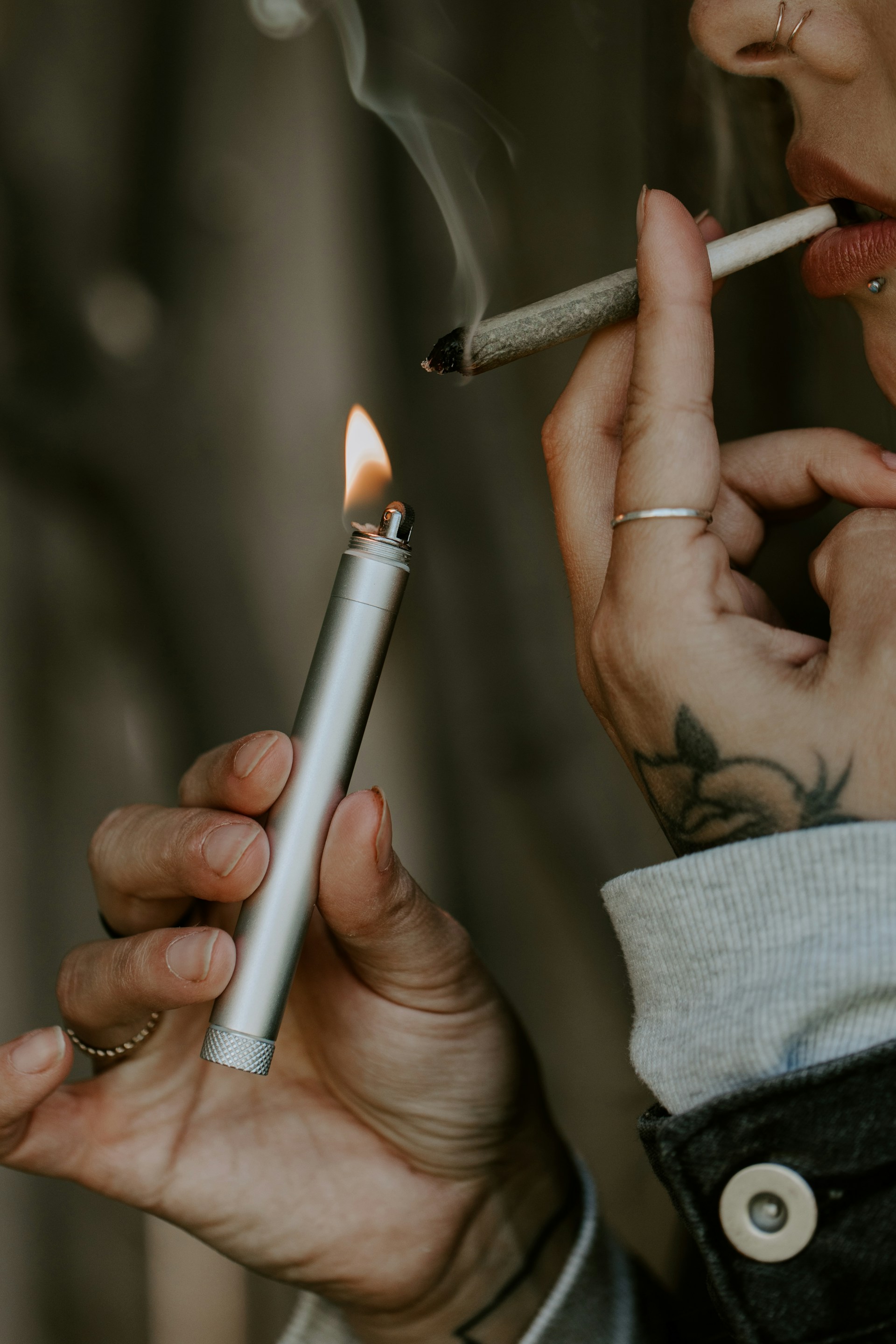 Woman lights joint with stick lighter (photo by Smoke Honest)